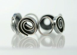 Erica Stankwytch Bailey, jeweler and teacher of metalsmithing and fabrication in Asheville, NC, creates contemporary, sterling silver, organic and architectural inspired jewelry.