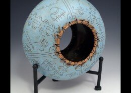 Melanie Walter, Mixed Media Artist in Wilmington, NC creates pine needle baskets by hand with black walnut, bamboo, cork, hickory nuts and clay details.