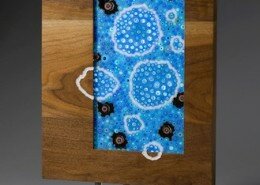 Teddy Devereux, Glass Artist in Durham, NC, creates fused iridized and dichroic glass wall hangings, sculptures and tiles inspired by patterns in nature.