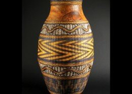 Jerry Maxey, basket maker and wood turner in Piedmont, SC creates wicker-weave basketry of dyed rattan, seagrass cord, and lathe turned wood bases and rims.